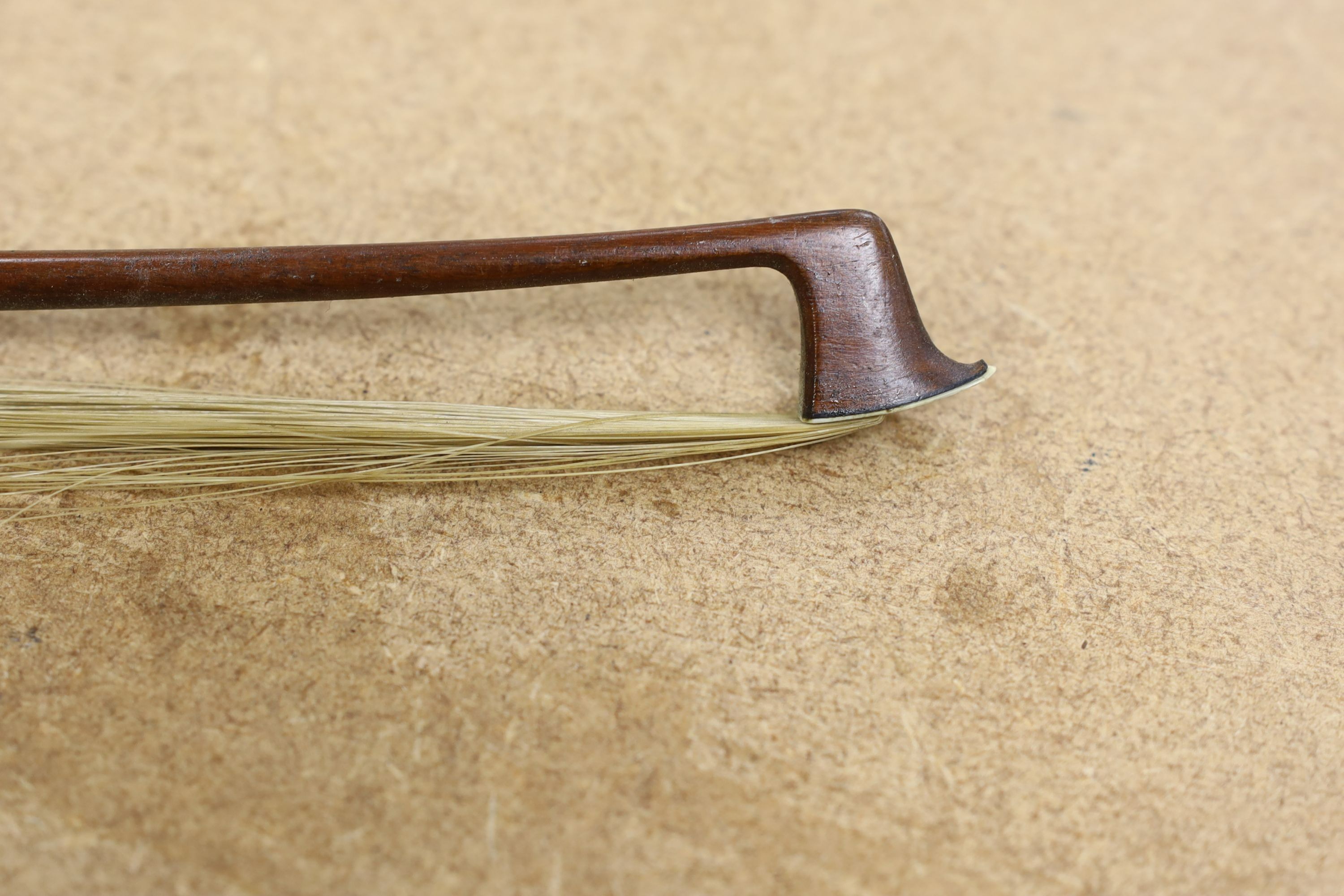 A 19th century violin with 14 inch 2 piece back, unlabelled, cased with silver mounted bow.